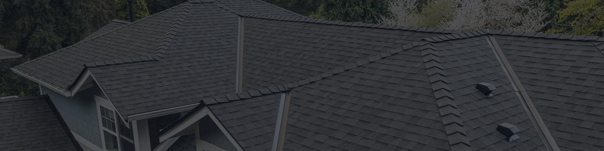 Freshly repaired grey asphalt roof in Seattle Washington