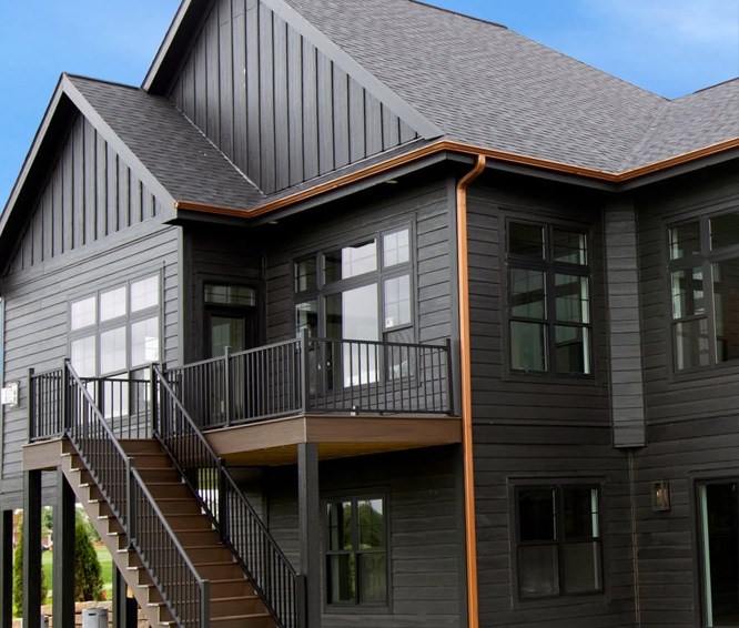Home with dark composite siding and board-and-batten accents