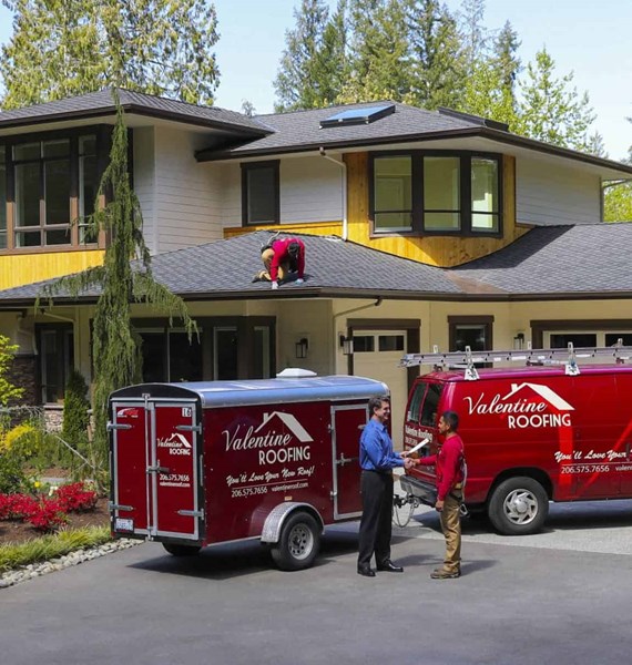 Roofing crew performing final walk through with happy customer and performing final clean up on job site after new roof shingle installation
