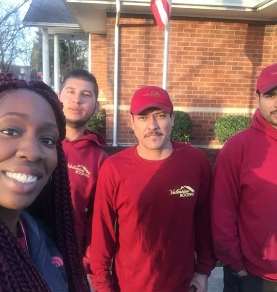 A lady homeowner taking selfie with our roofers