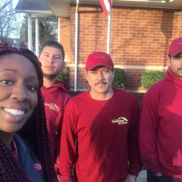 A lady homeowner taking selfie with our roofers