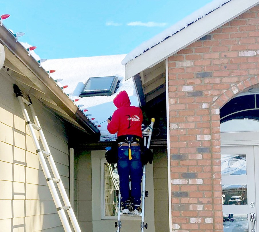 our christmas light installer in Kent, WA installing holiday lights