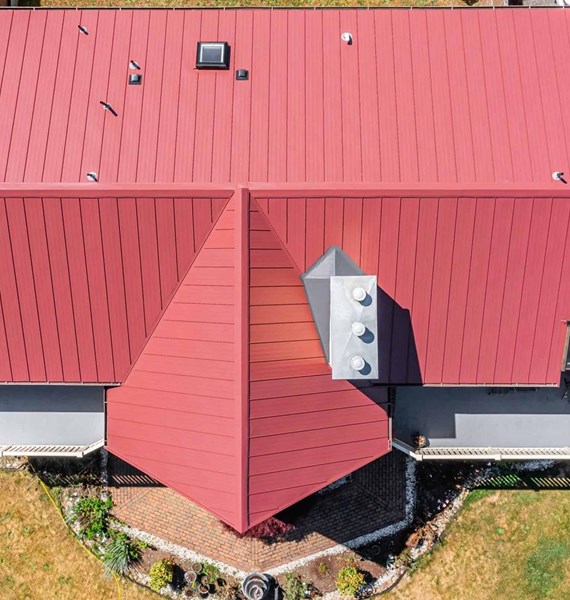 Roy Standing Seam Metal Panel in Colonial Red on two story home