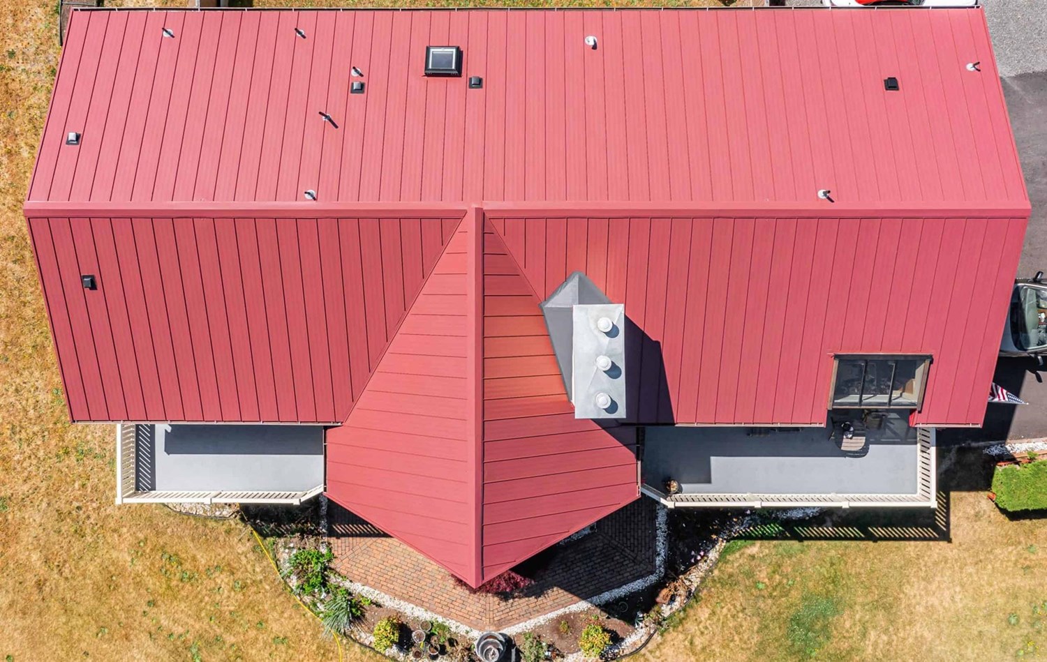 Roy Standing Seam Metal Panel in Colonial Red on two story home