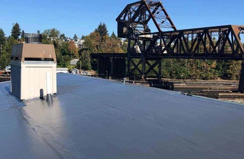 A dark brown PVC single ply roof membrane on a business in Ballard, WA 
