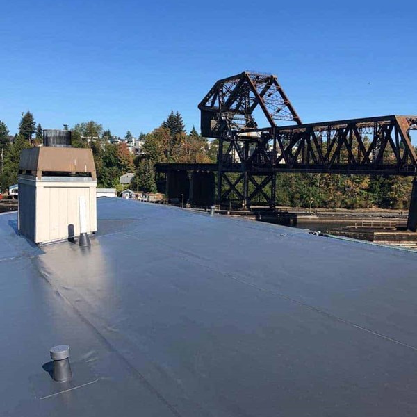 A dark brown PVC single ply roof membrane on a business in Ballard, WA