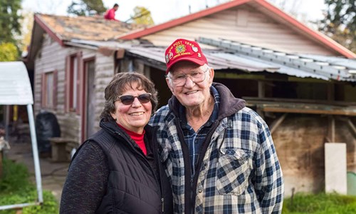 Meet Floyd Floyd and his wife standing in front of their newly renovated home