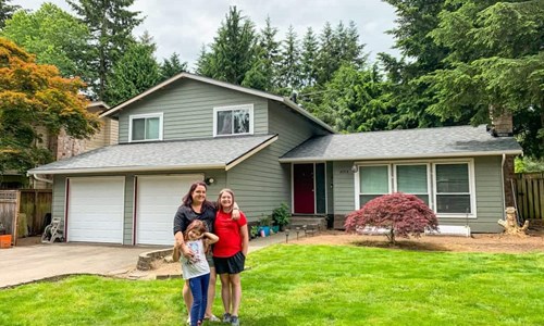 Lisa and her family in front of her house