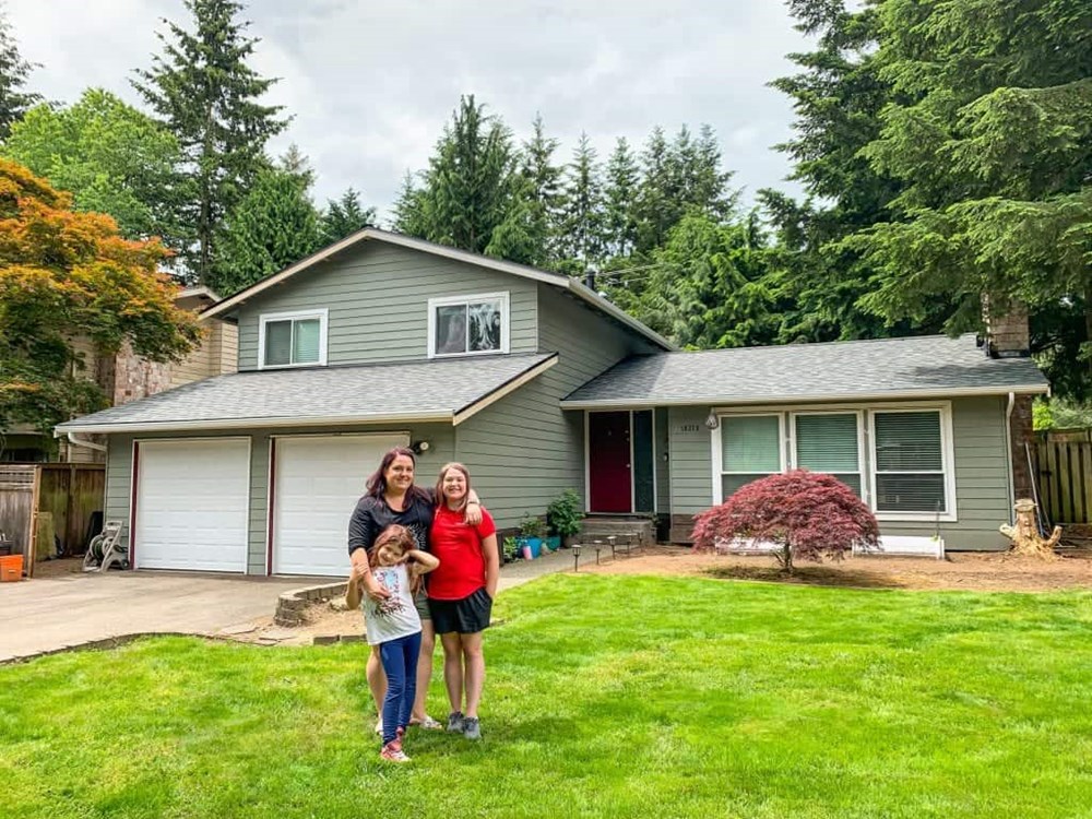 Lisa and her family in front of her house