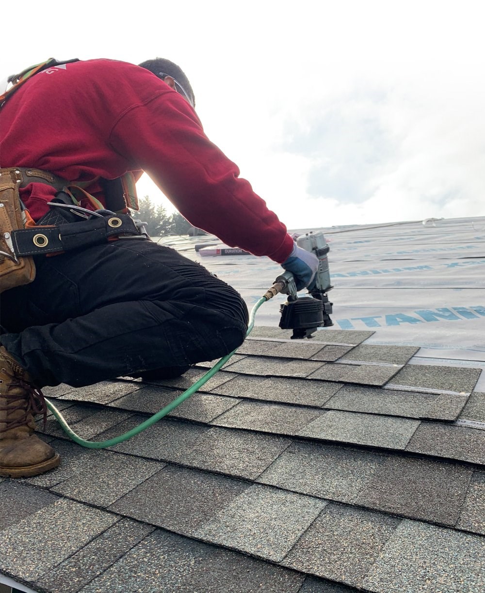 Professional roofer repairing damaged shingles in Seattle