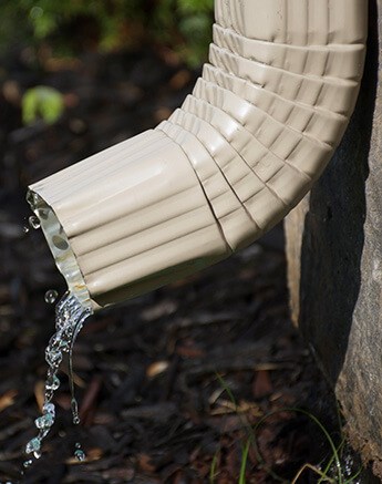 checking gutter condition during roof inspection in Washington