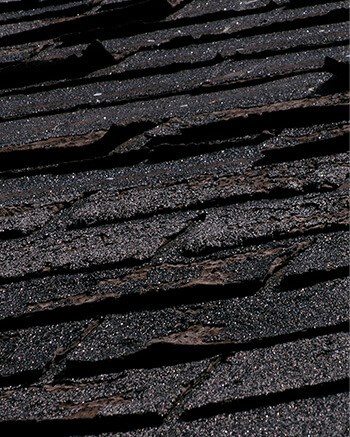 checking shingle condition during roof inspection in Washington